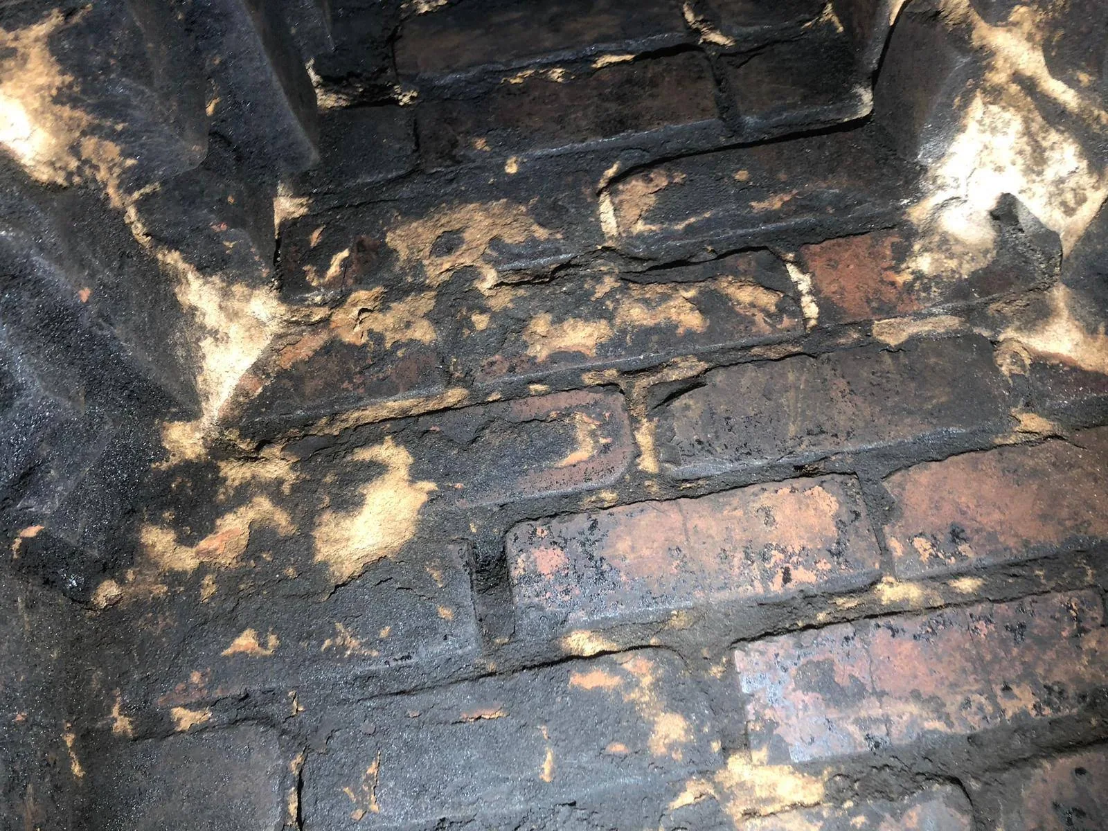 Close view of masonry inside a chimney or firebox during an owner-supplied service project