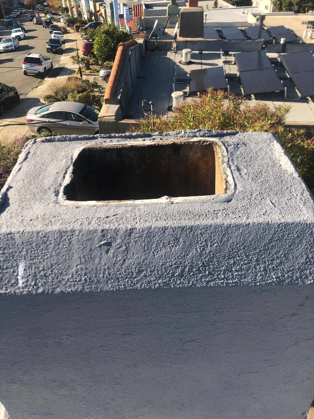 Freshly finished chimney crown surface around a flue opening